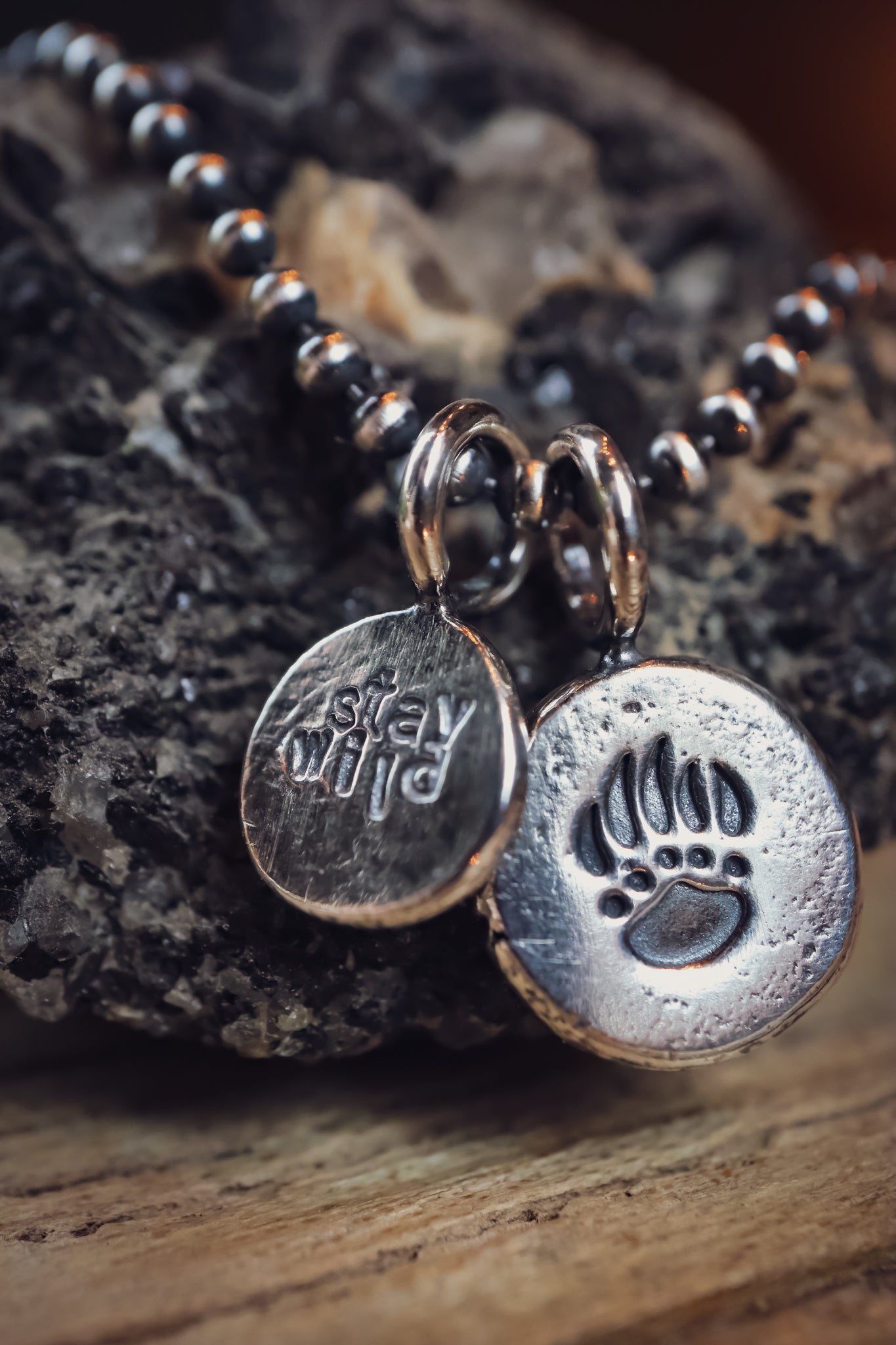 the Stay Wild Bear Track Necklace (reclaimed sterling silver)