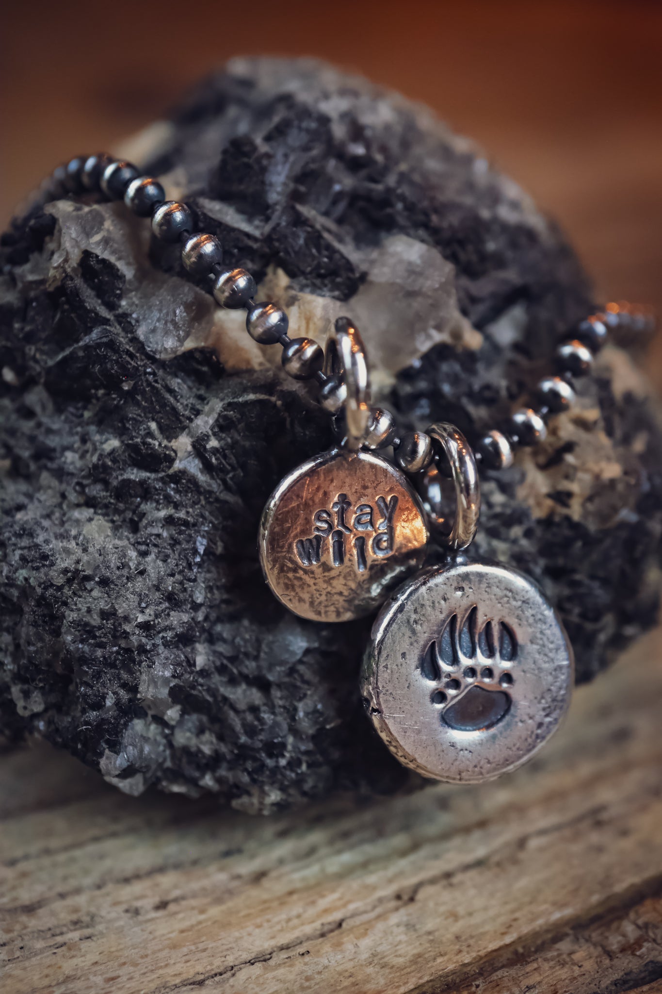 the Stay Wild Bear Track Necklace (reclaimed sterling silver)