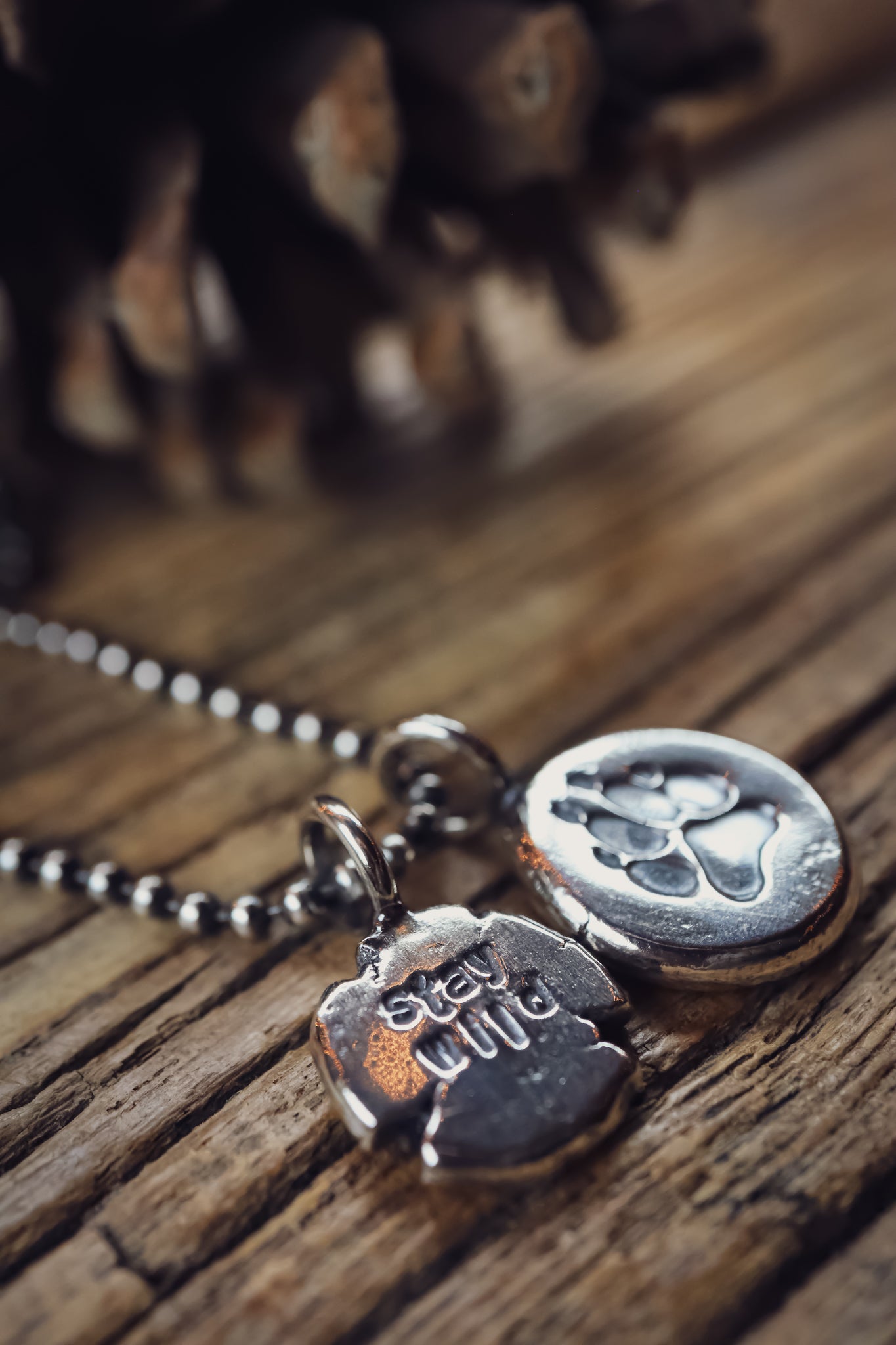 the Stay Wild Wolf Track Necklace (reclaimed sterling silver)