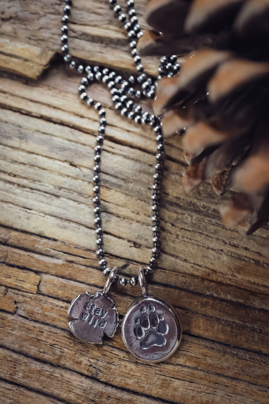 the Stay Wild Wolf Track Necklace (reclaimed sterling silver)