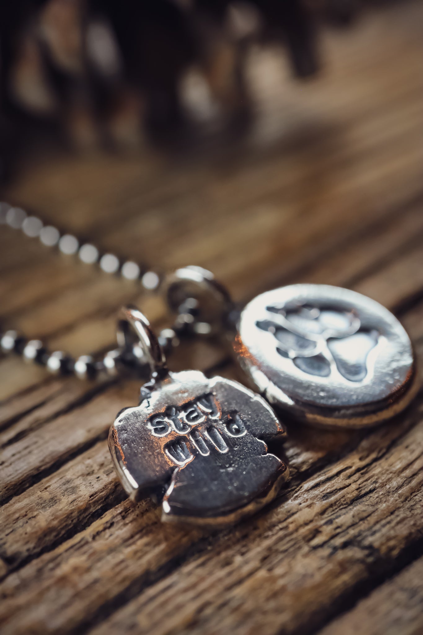 the Stay Wild Wolf Track Necklace (reclaimed sterling silver)