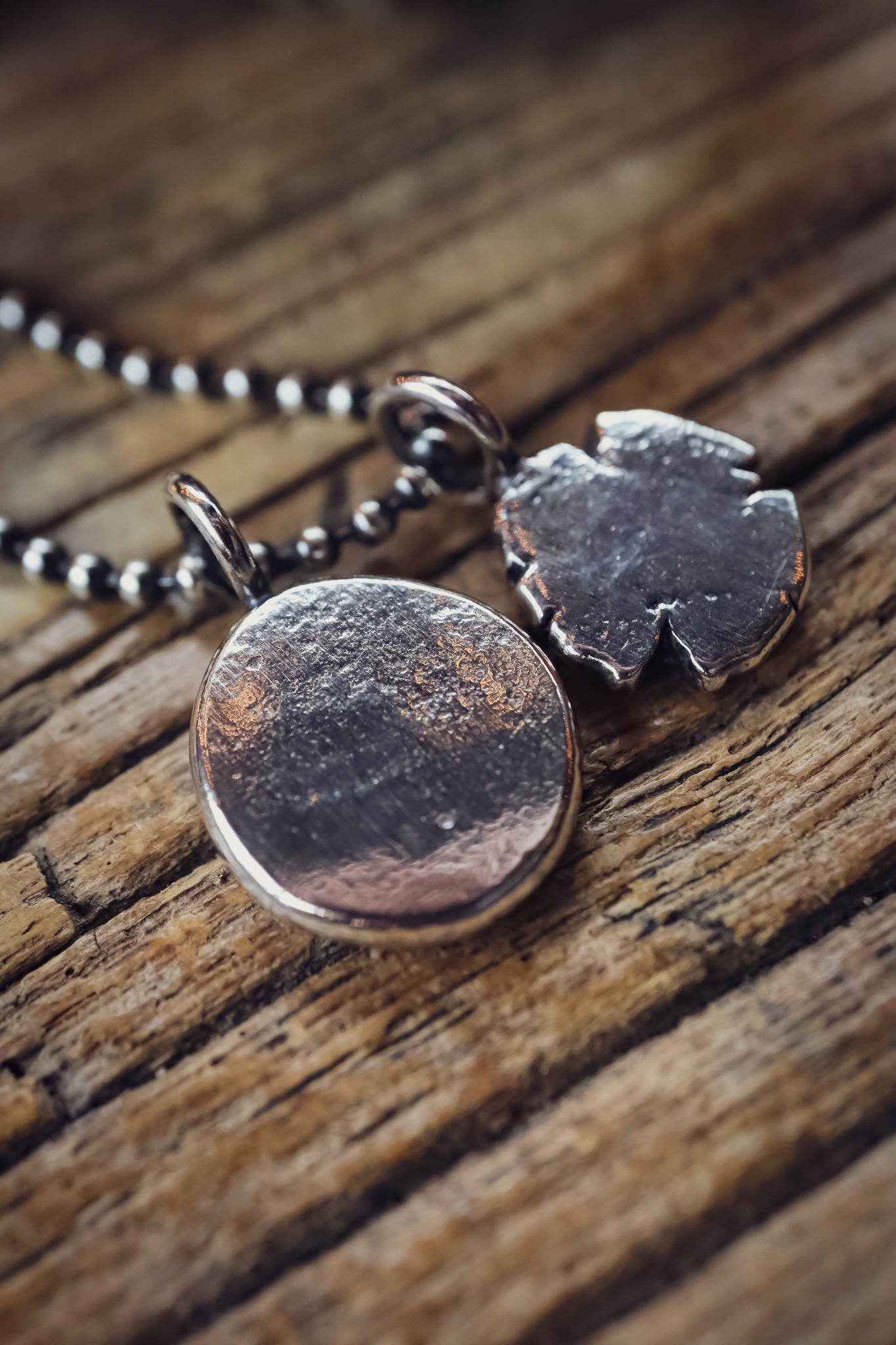 the Stay Wild Wolf Track Necklace (reclaimed sterling silver)